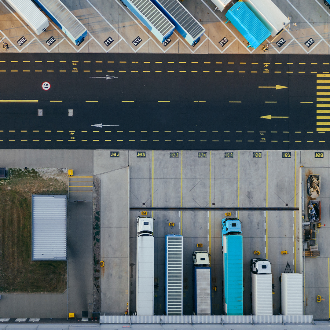 Warehouse parking lot aerial with trucks