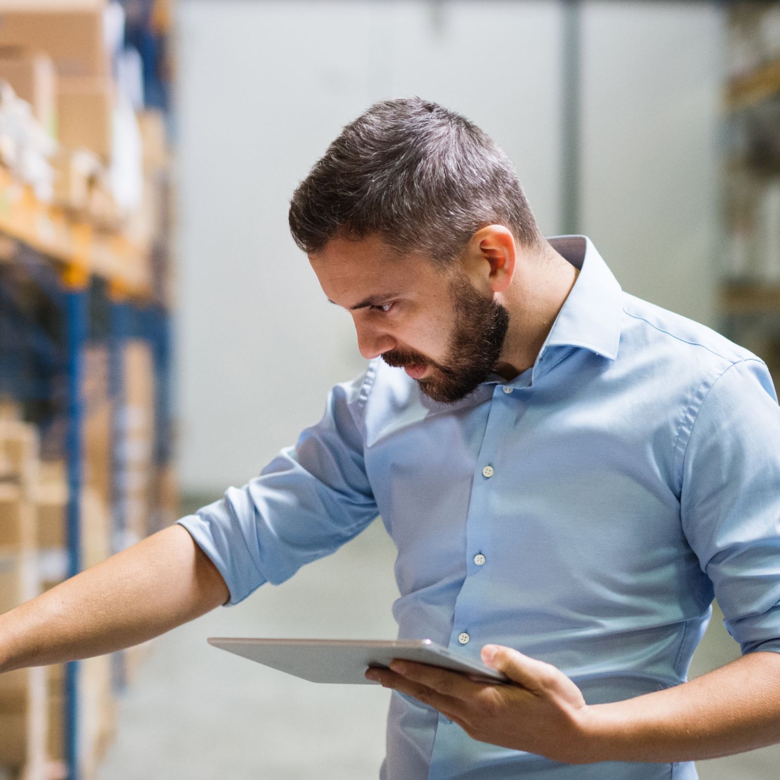 Manager checking inventory in warehouse